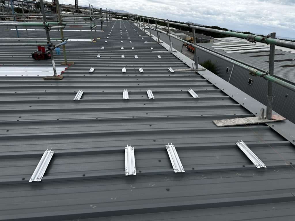 Commercial roof prepared with mounting rails for solar panel installation