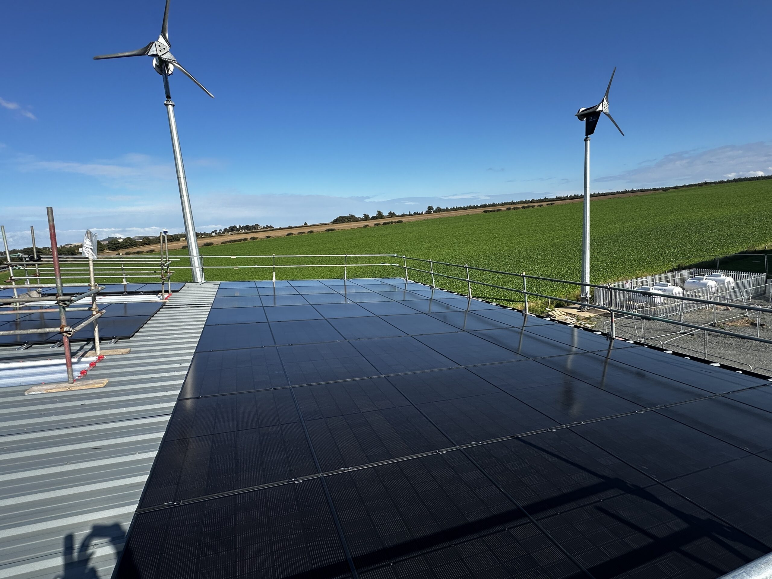 Commercial solar panels installed on a large industrial roof in Scotland